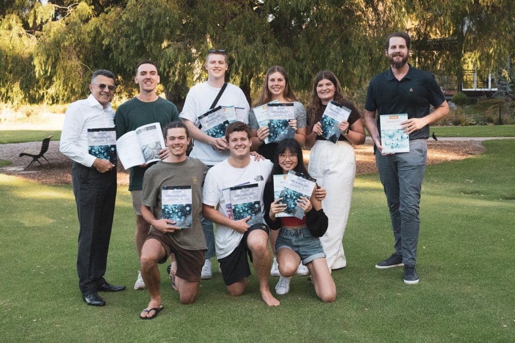 Elucidate staff team holding textbooks