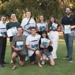 Elucidate staff team holding textbooks