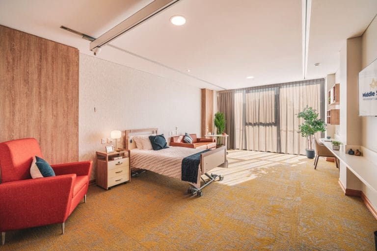 Large aged care suite shown in bed + living configuration