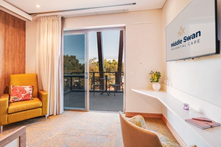 Aged care suite showing private balcony outside the suite's sitting area