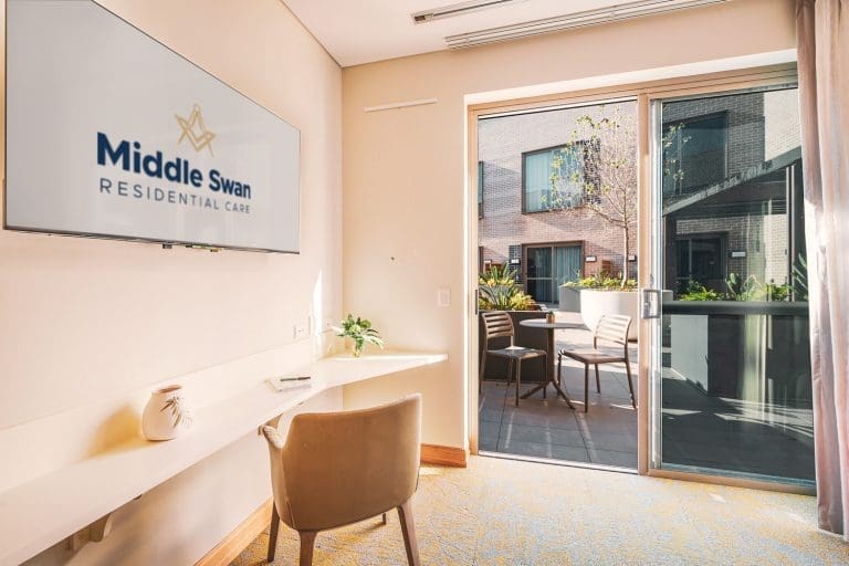 Aged care suite sitting area with private courtyard in the background