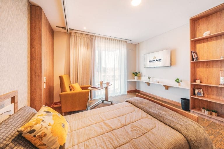 Aged care suite with bed and sitting area configuration